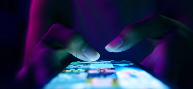 woman's thumbs typing on phone