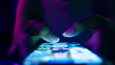 woman's thumbs typing on phone