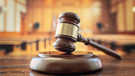 image of a gavel on a courtroom desk