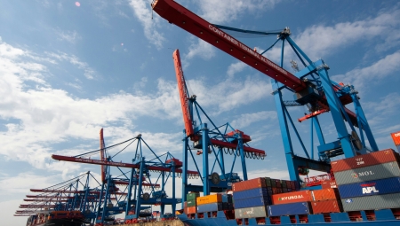 Cranes and shipping containers in a port.